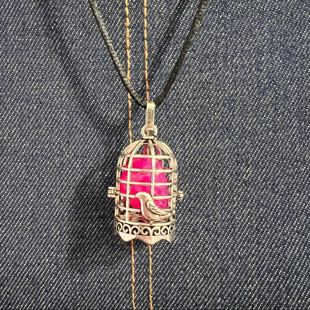This is a beautiful Polished Pink Agate  Gemstone With a bird Charm cage .